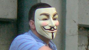 Marc Headley wearing an “Anonymous” mask