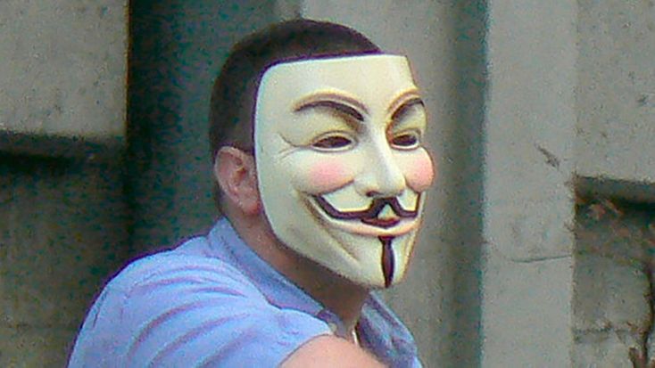 Marc Headley wearing an “Anonymous” mask